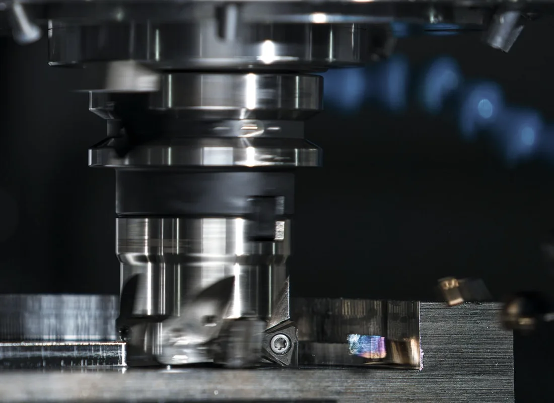 Precision milling machine cutting a metal component