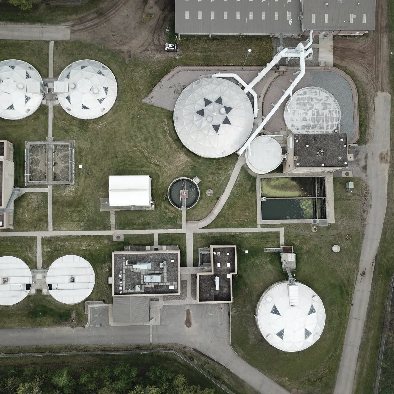 Aerial view of circular water treatment tanks and connecting infrastructure